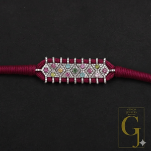 Bracelet with colorful gemstones on a dark background, featuring the Gemco Jewelry logo.