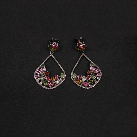 Pair of earrings with colorful gemstones on a black background