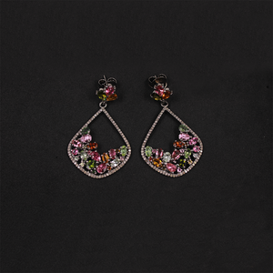 Pair of earrings with colorful gemstones on a black background