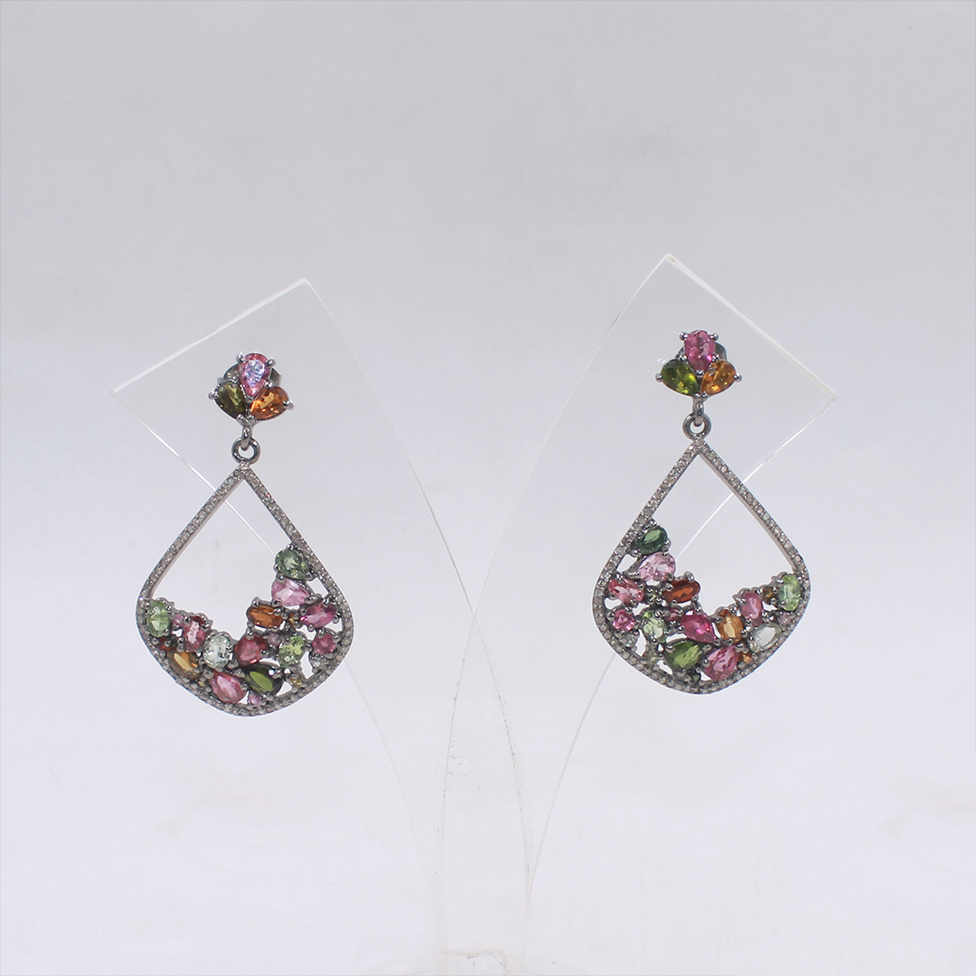 Pair of earrings with multicolored gemstones on a white background