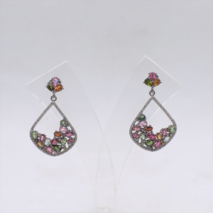 Pair of earrings with multicolored gemstones on a white background