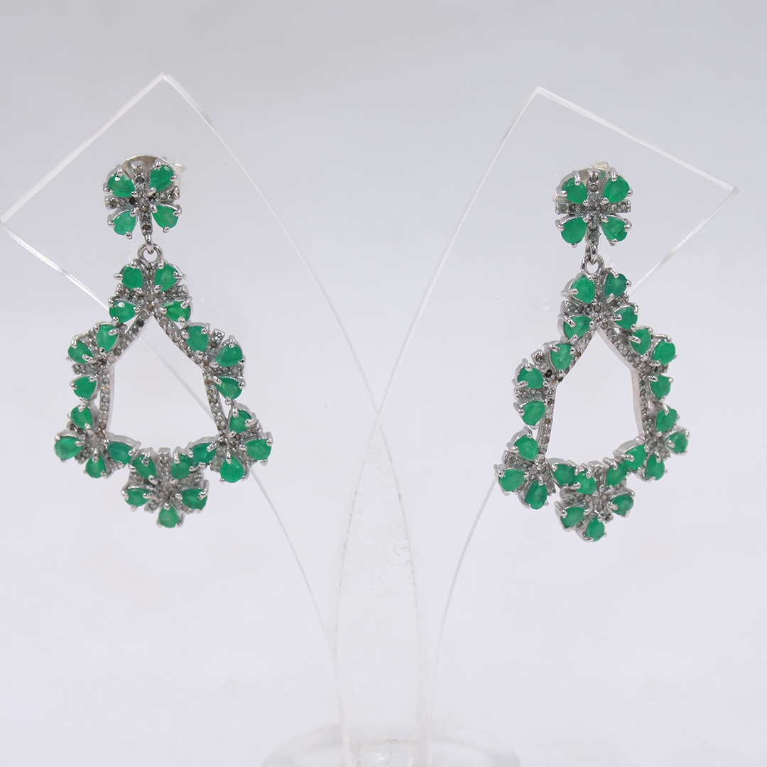 Pair of green teardrop earrings on a white background