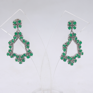 Pair of green teardrop earrings on a white background