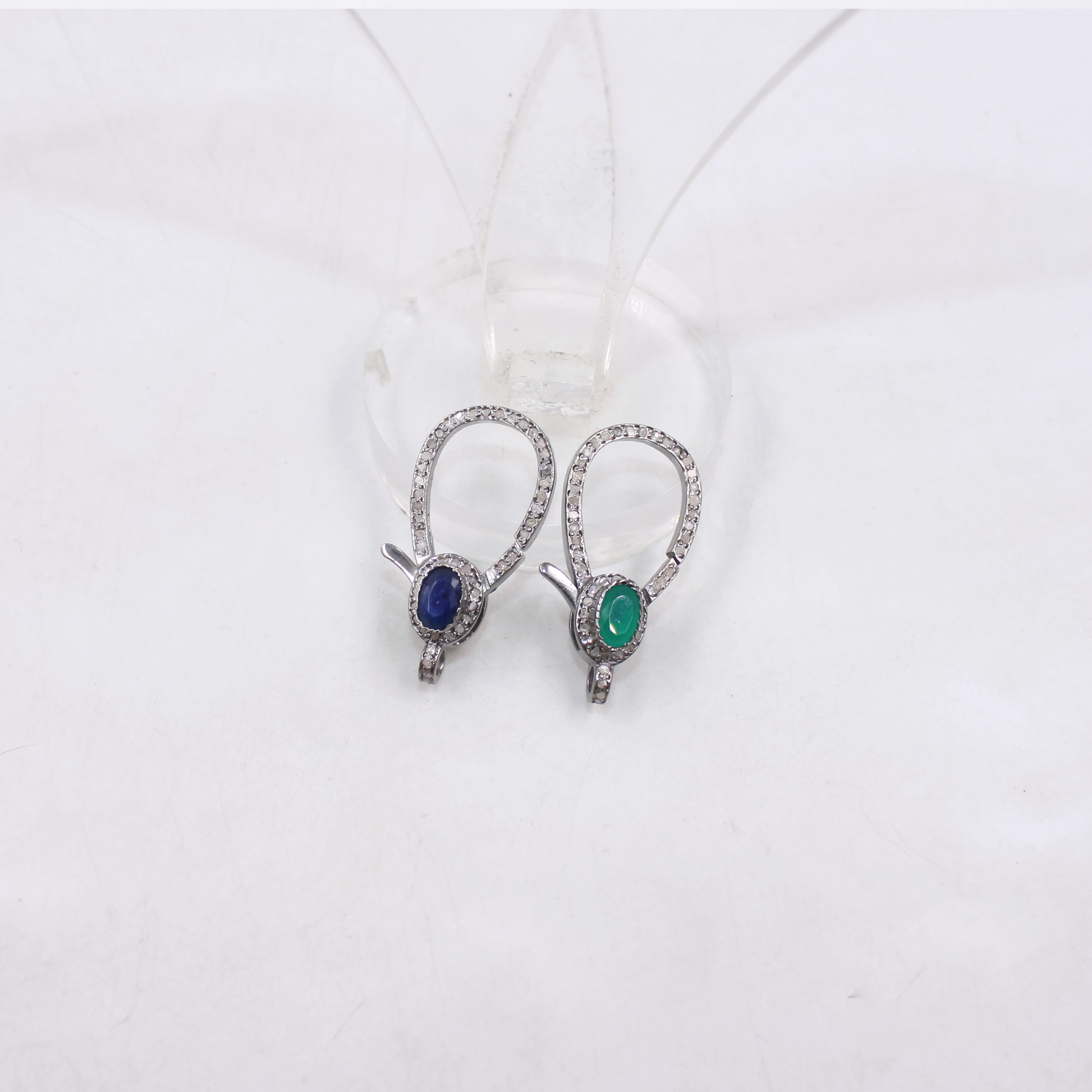 Pair of earrings with gemstones on a white background