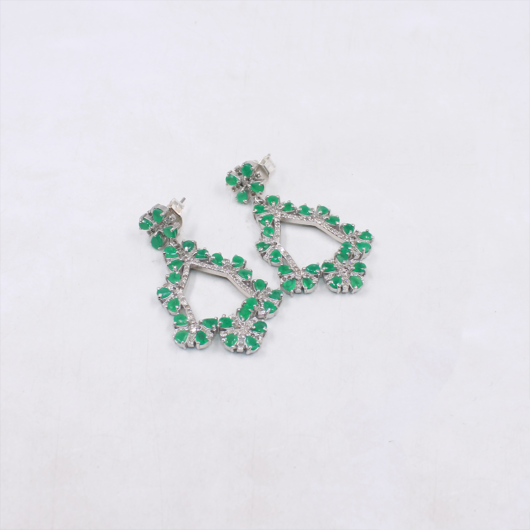 Green gemstone earrings on a white background