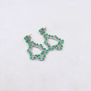Green gemstone earrings on a white background