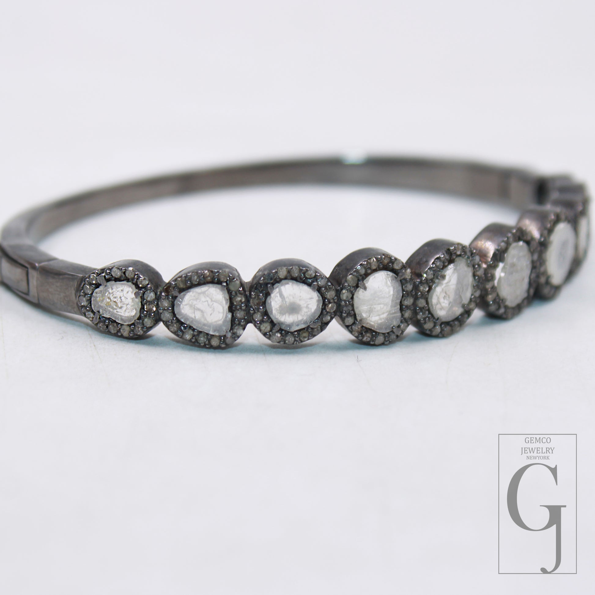 Close-up of Polki diamond bangle with intricate silver work