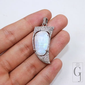 Shark tooth shaped moonstone pendant with pave diamond border