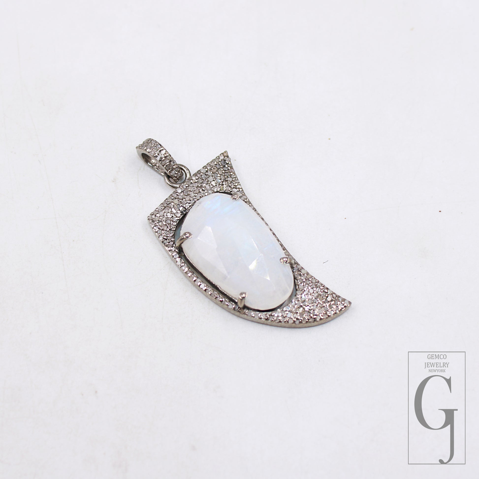 Handcrafted gemstone charm with shark tooth shape