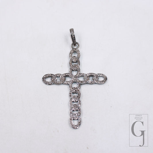 A sterling silver cross pendant with rose cut pave diamond design, displayed against a white background.
