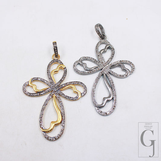 Two cross-shaped pendants made of 925 sterling silver, one with a gold plating on the top and both adorned with rose cut pave diamond designs.