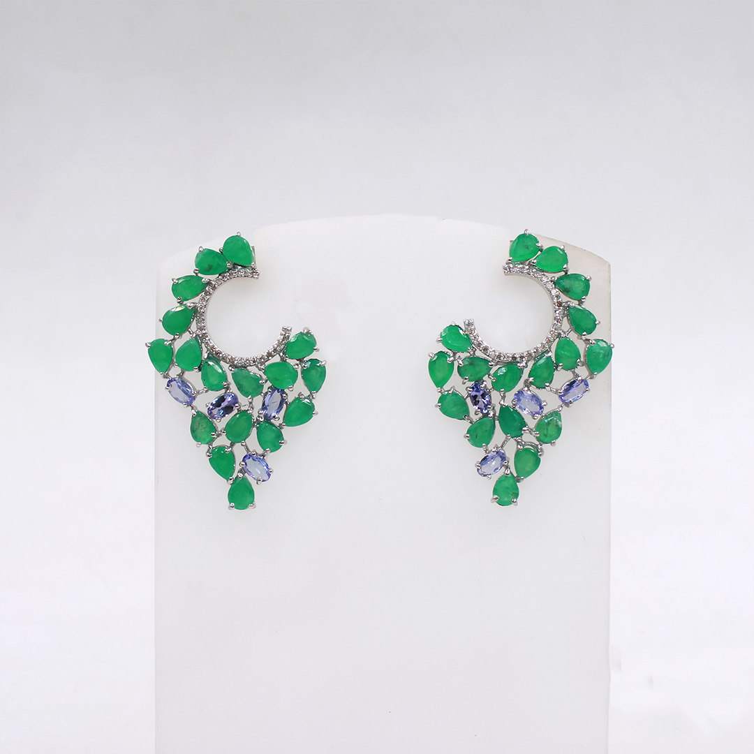 Pair of green gemstone earrings on a white card