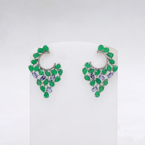 Pair of green gemstone earrings on a white card