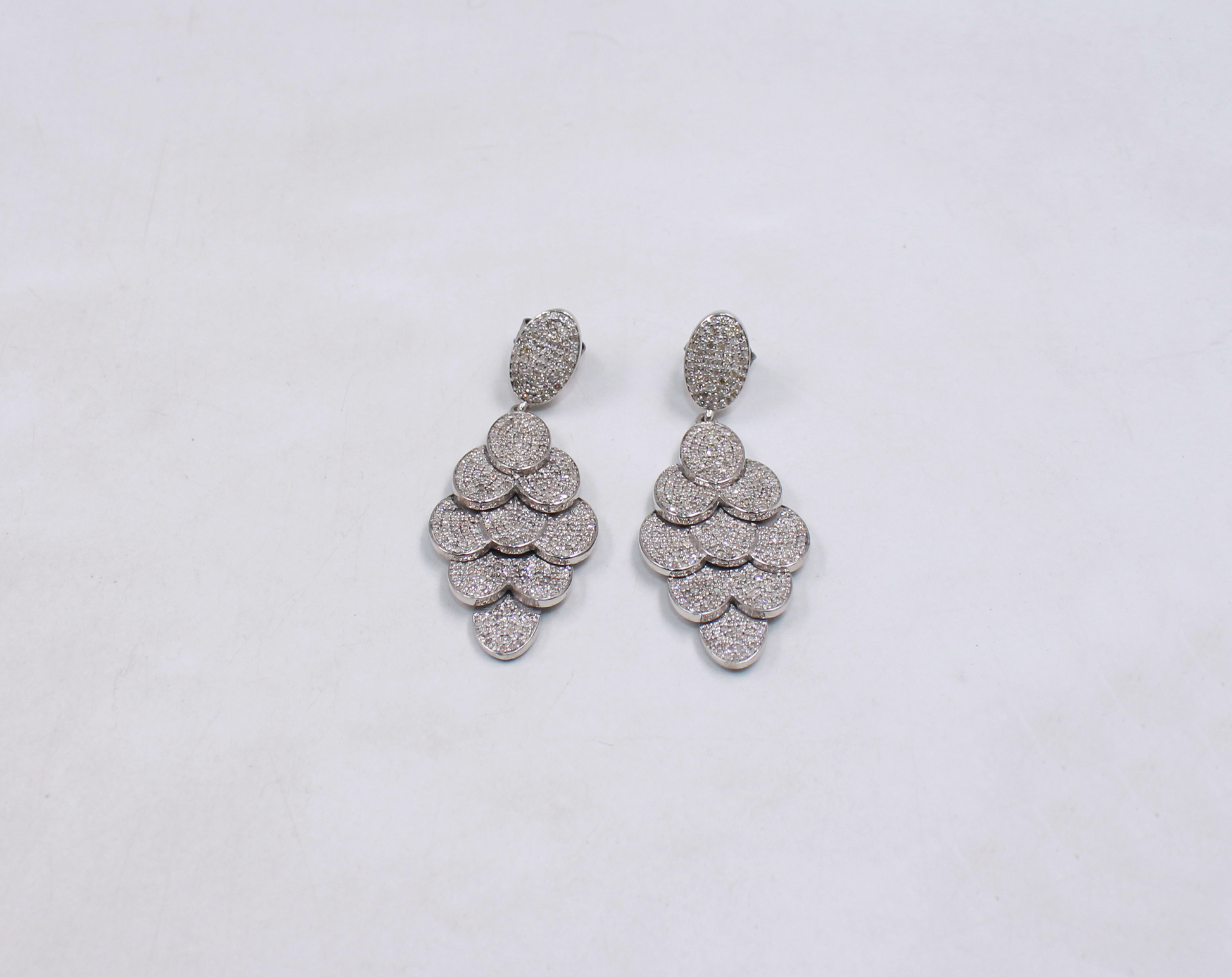 Pair of silver earrings on a light gray background