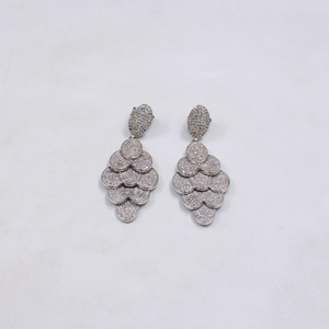 Pair of silver earrings on a light gray background