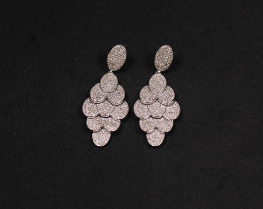 Pair of silver earrings on a black background