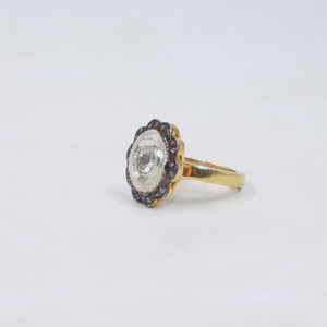 Gold ring with a diamond on a light gray background