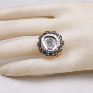 Silver ring with a large central stone on a mannequin hand