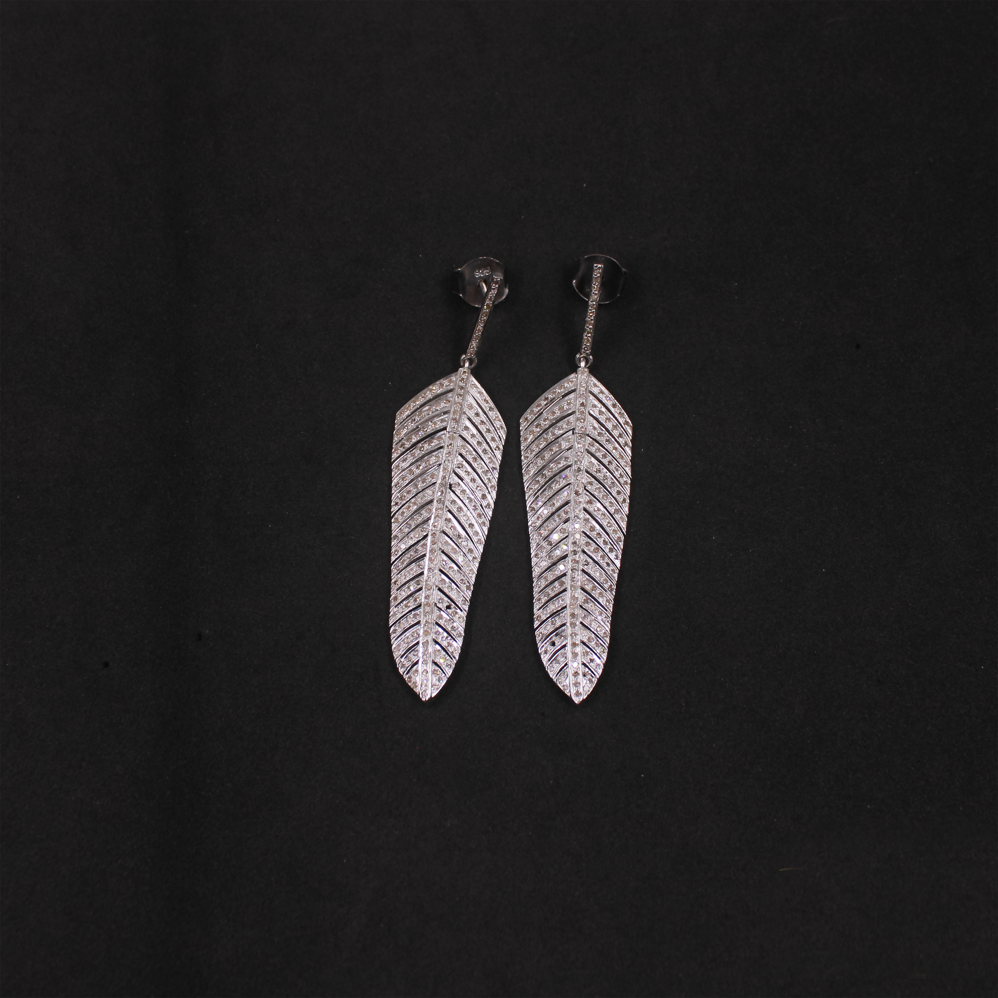 Elegant feather-inspired pave diamond drop earrings