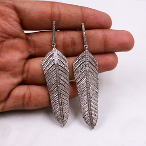 Artisan-crafted feather earrings with sparkling diamonds