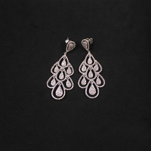 Pair of silver chandelier earrings on a black background