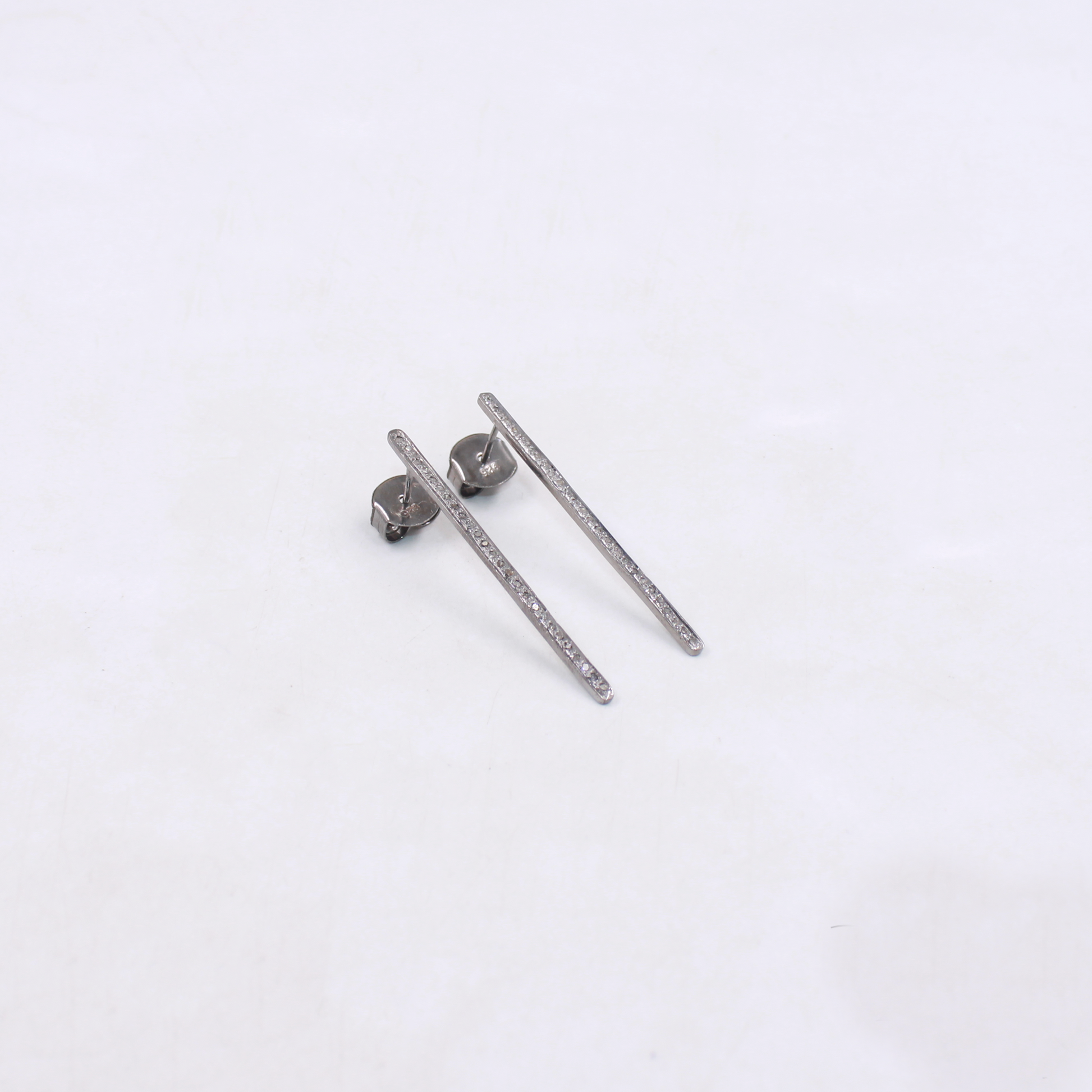Modern silver diamond earrings with elongated bar design