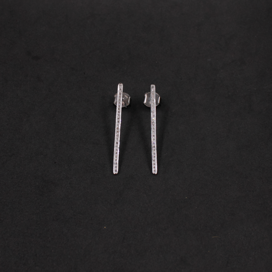 Pair of silver bar earrings on a black background