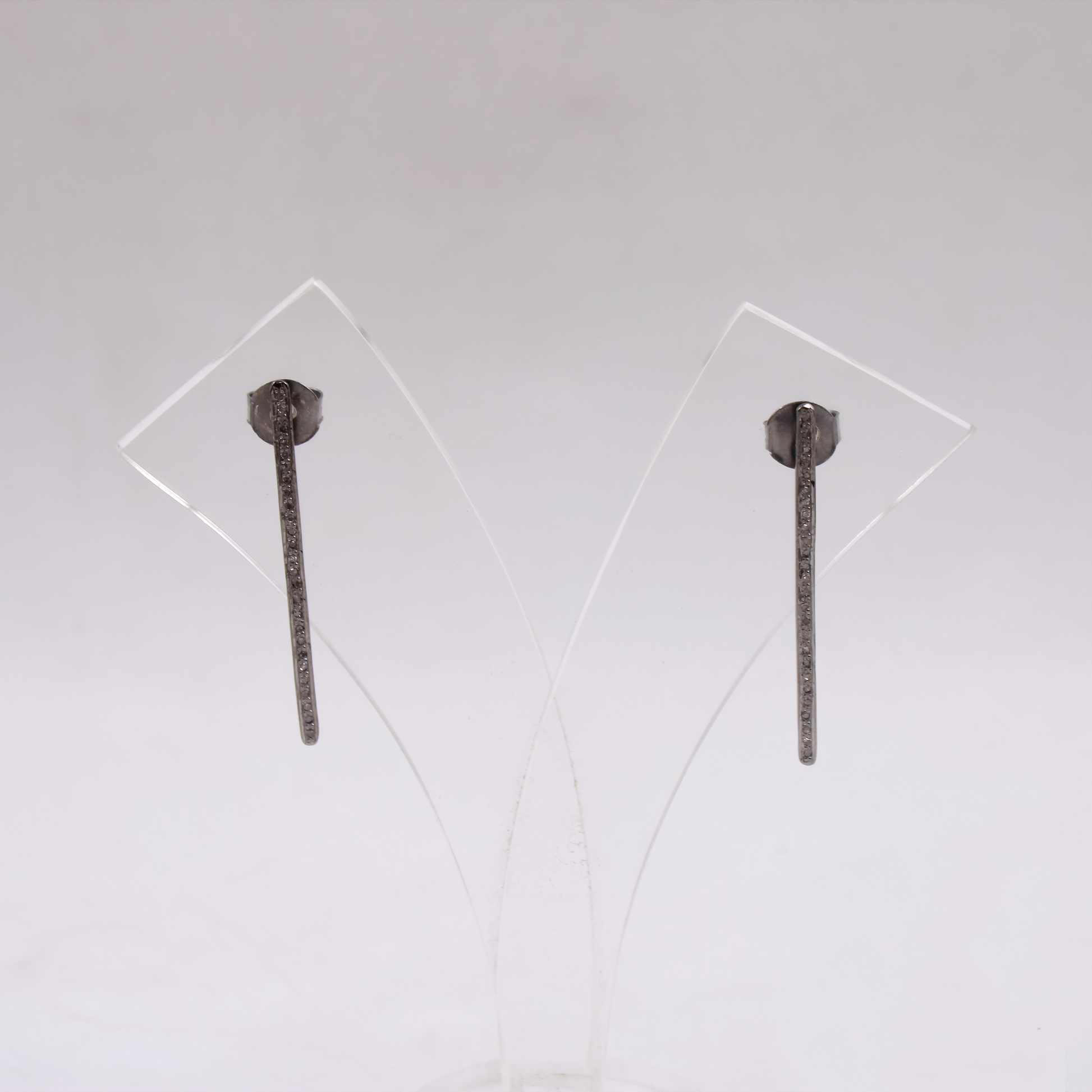 Minimalist diamond drop earrings with rhodium polish