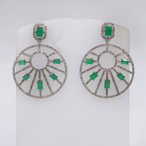 Pair of earrings with green gemstones on a white background