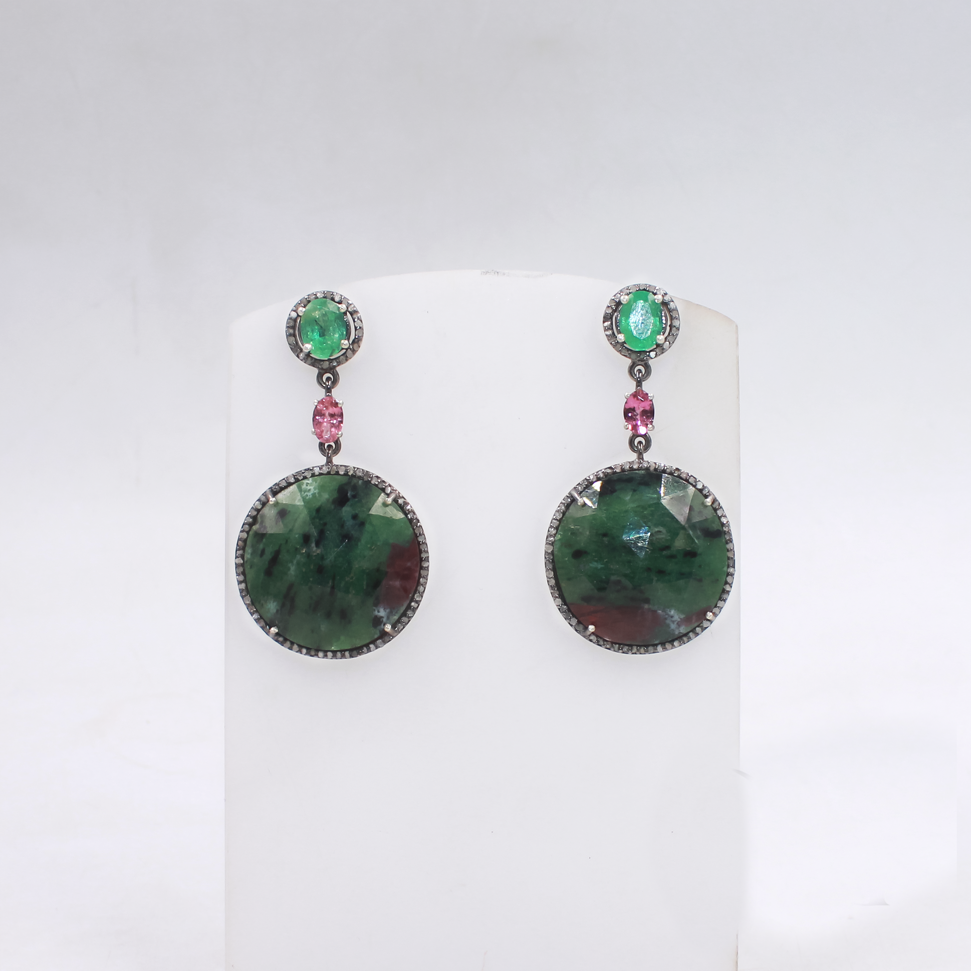 Collector’s gemstone earrings with artistic emerald and tourmaline design