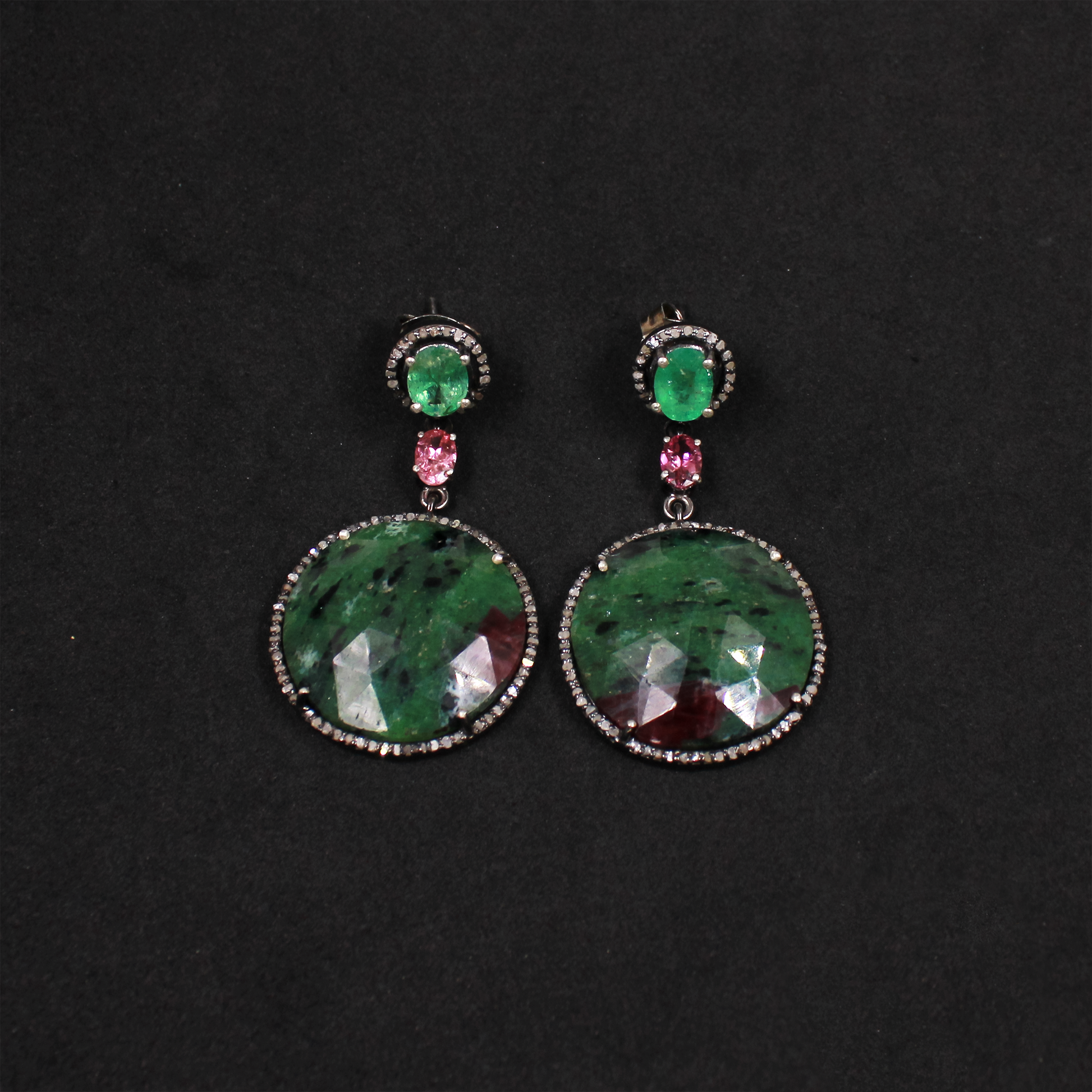 Statement dangle earrings featuring rosecut pave diamonds and emeralds