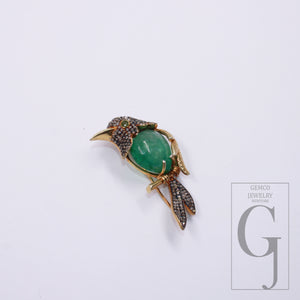 14k gold finish bird pendant featuring green, emerald center
