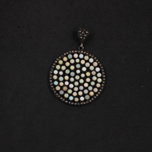 Round pendant with multicolored stones on a black background