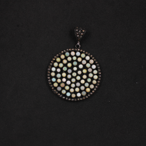 Round pendant with multicolored stones on a black background