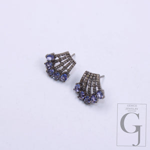 Close-up of handcrafted tanzanite and rosecut diamond stud earrings 