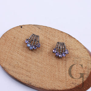 Close-up craftsmanship of handmade sterling silver gemstone earrings.