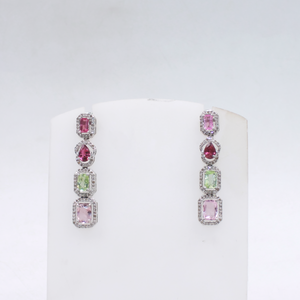 Long gemstone earrings featuring emerald cut, oval, and cushion tourmalines