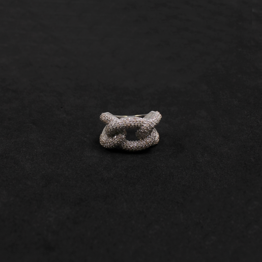Silver ring with a textured design on a black background