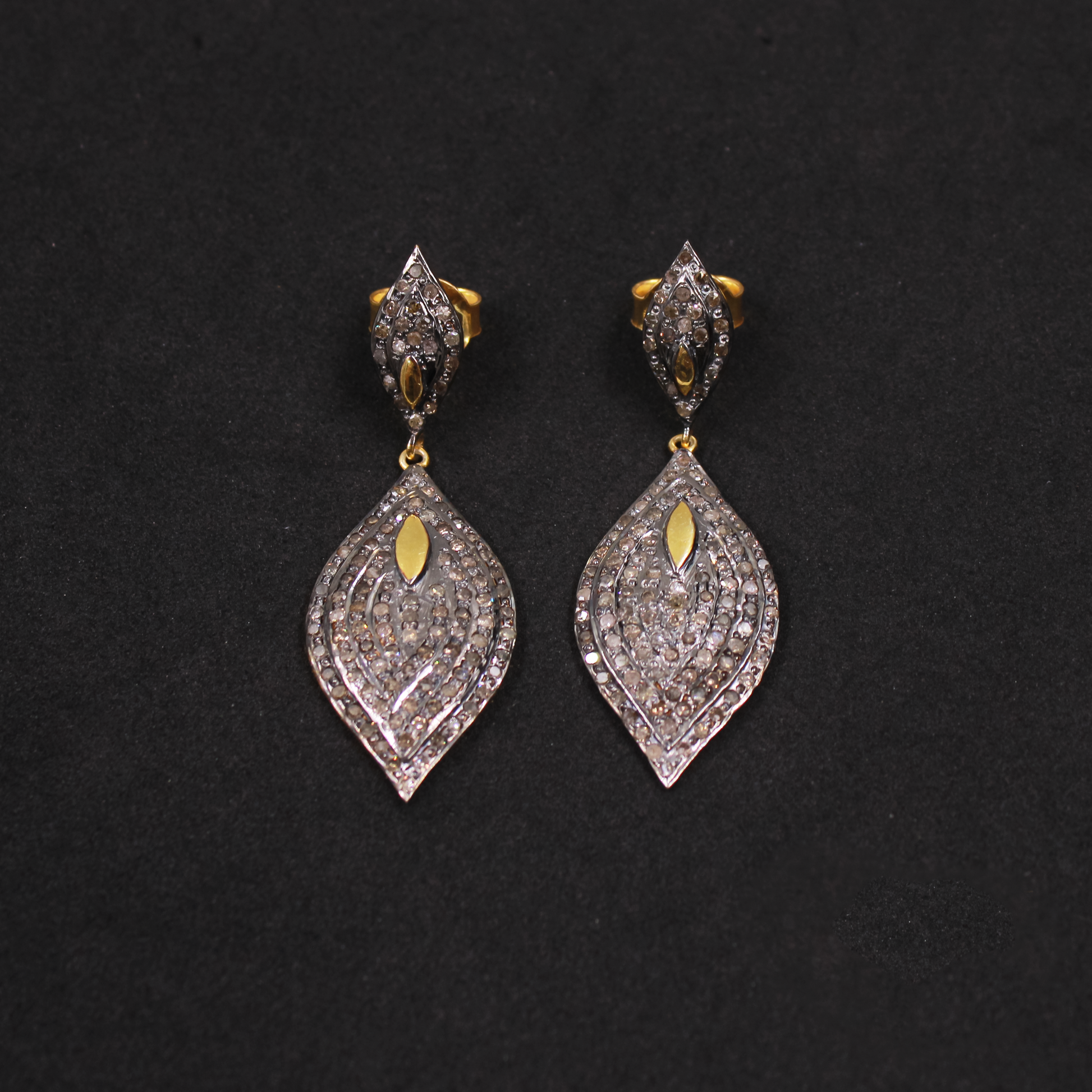 Pair of diamond earrings on a black background