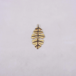 Gold leaf-shaped pendant on a light gray background
