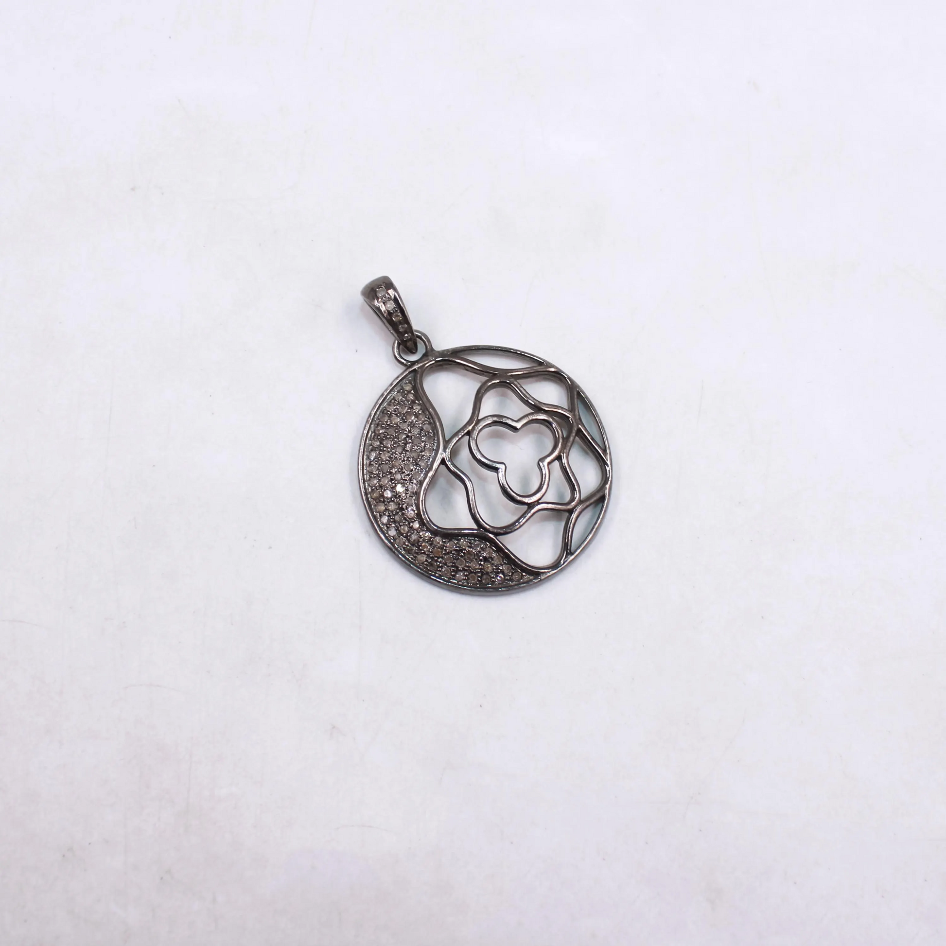 Silver floral pendant on a white background
