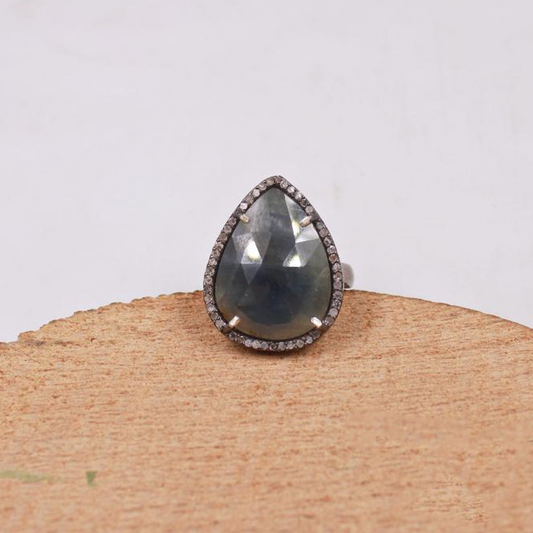 Handmade pear cut blue sapphire ring with pave diamonds in oxidized silver