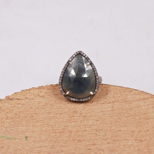 Handmade pear cut blue sapphire ring with pave diamonds in oxidized silver