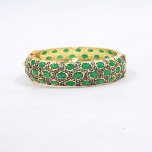 Gold plated sterling silver bangle with natural emeralds and diamonds