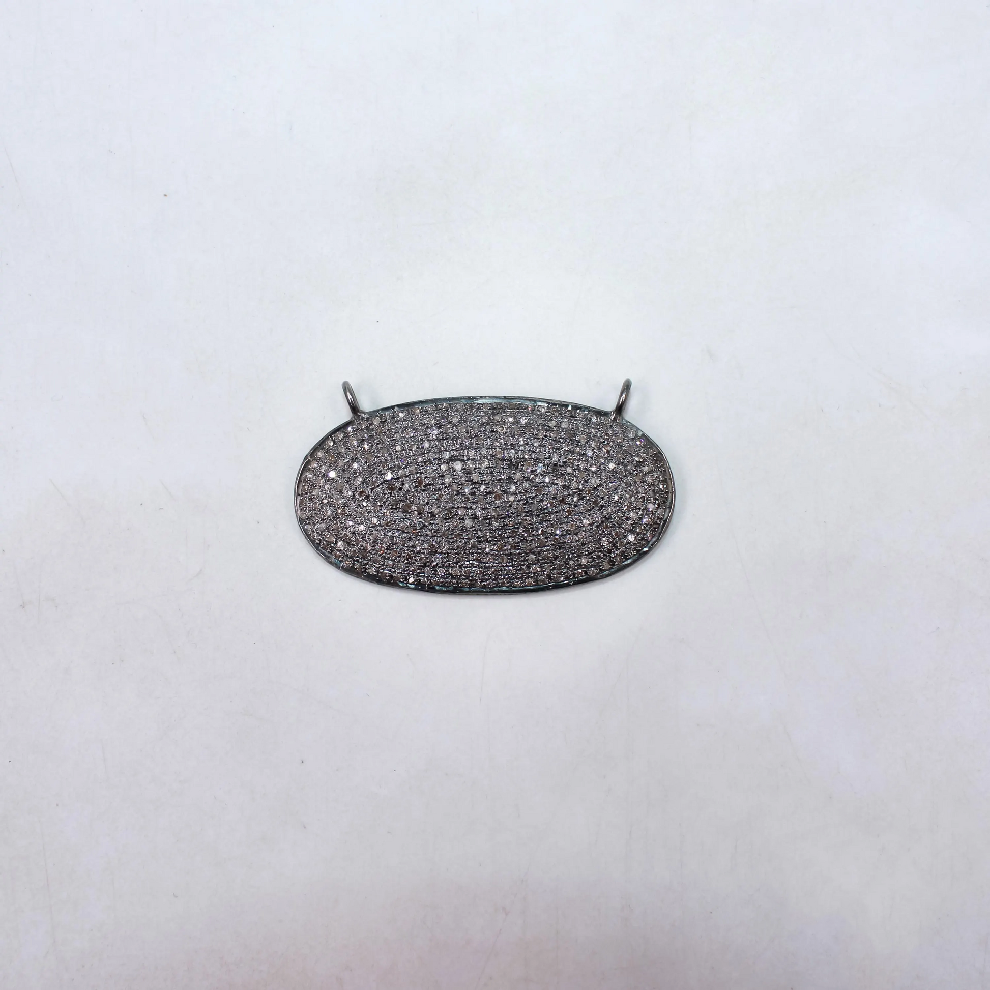 Silver necklace pendant on a white background
