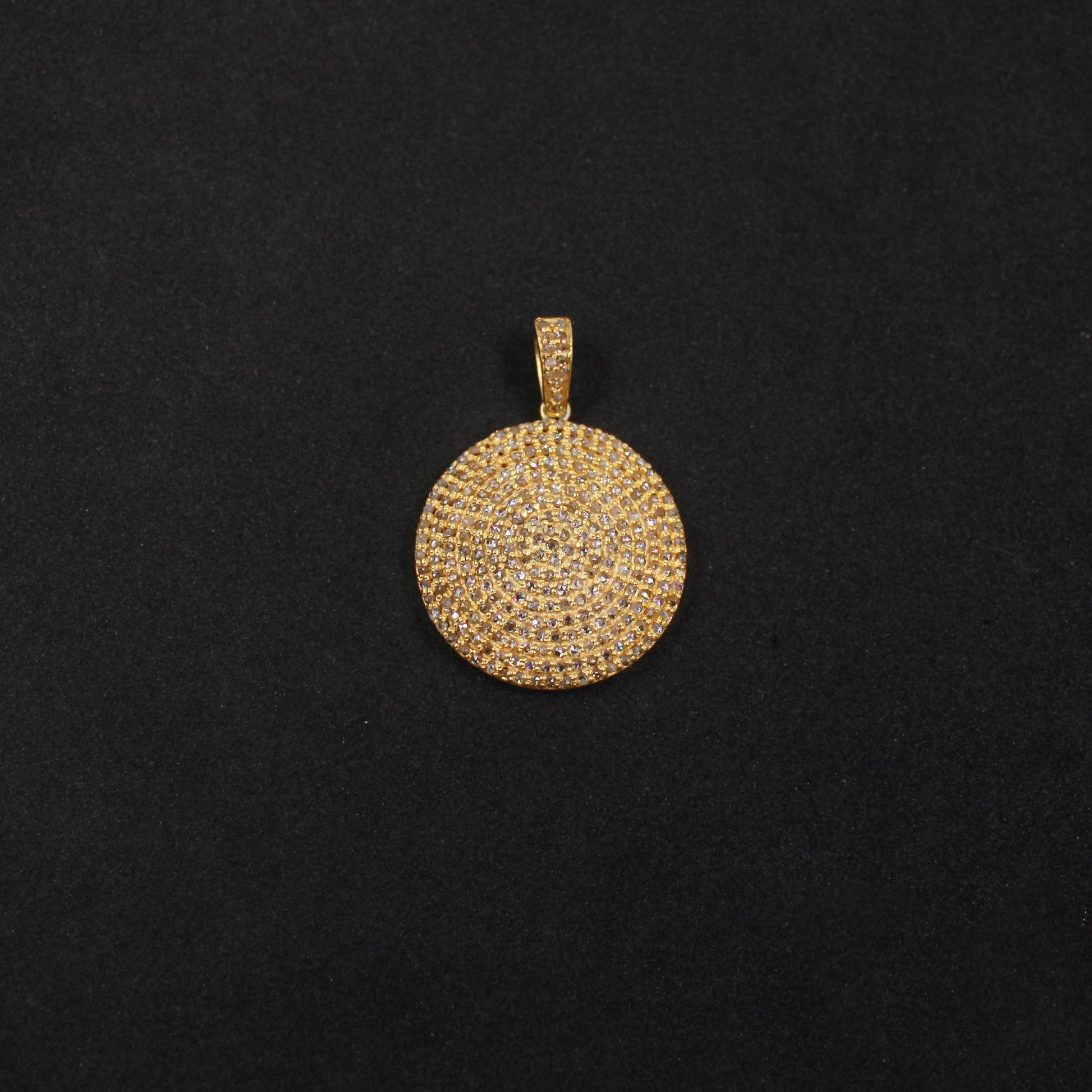 Gold pendant on a black background
