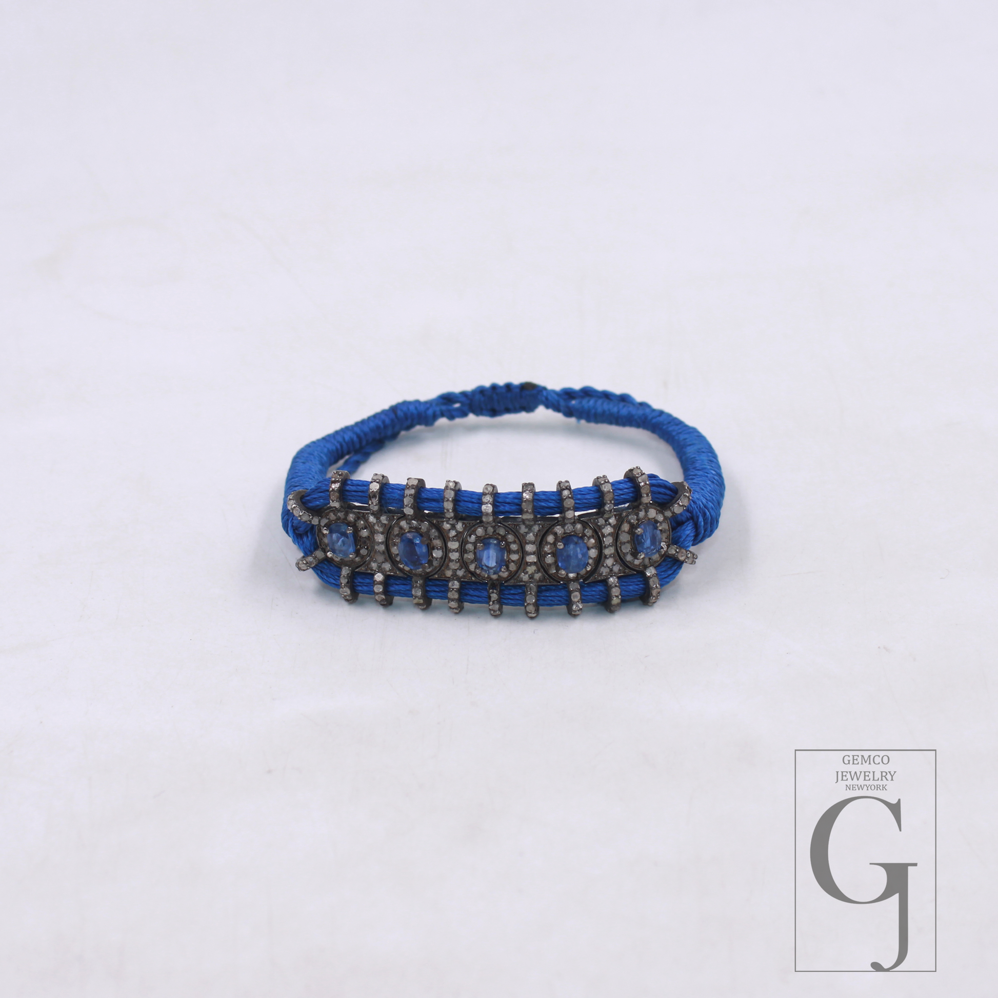 Close-up of natural kyanite stone with rosecut diamond macrame setting