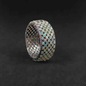 Silver ring with opal stones on a black background