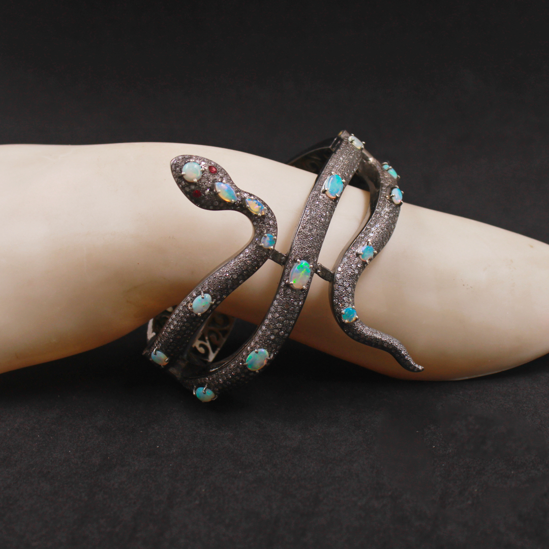 Decorative bracelet with gemstones on a wrist against a dark background
