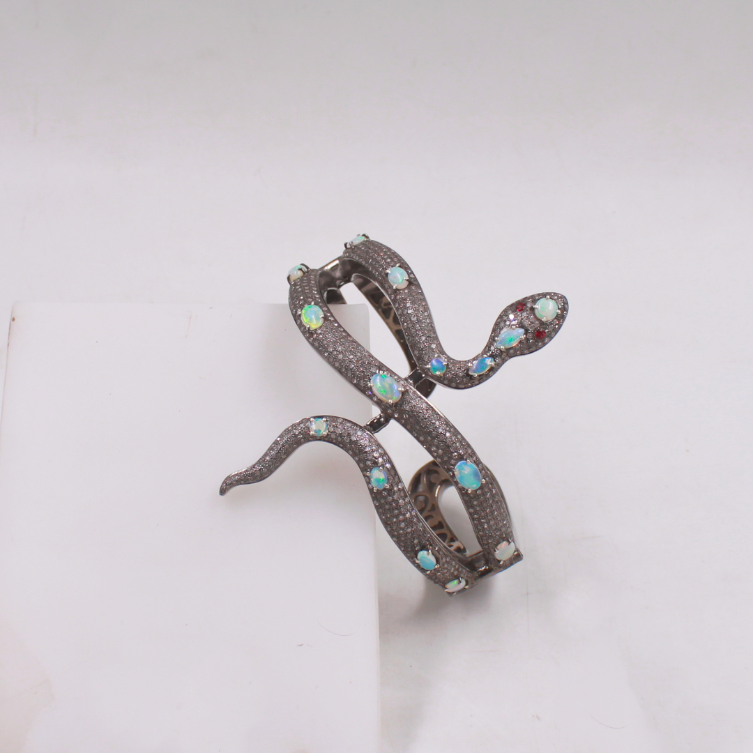 Decorative brooch with snake design on a white background